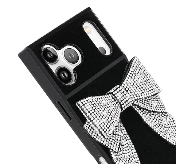 Black phone case with crystal embellished bow on a white background