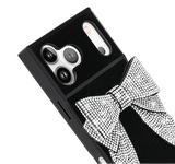 Black phone case with crystal embellished bow on a white background