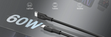 A 60W black USB-C to USB-C cable shown diagonally on a dark gray background with icons indicating compatibility with laptops, tablets, and mobiles.