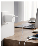 Collage of a person using a smartphone with a power adapter on a desk.